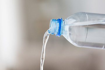 Image showing close up of water pouring from plastic bottle