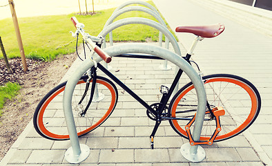 Image showing close up of bicycle locked at street parking