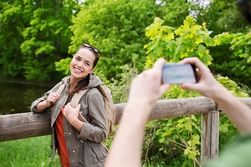 Image showing couple with backpacks taking picture by smartphone