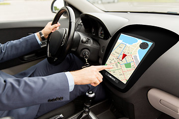 Image showing close up of man driving car with gps navigator map