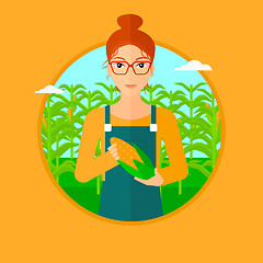 Image showing Farmer holding corn.