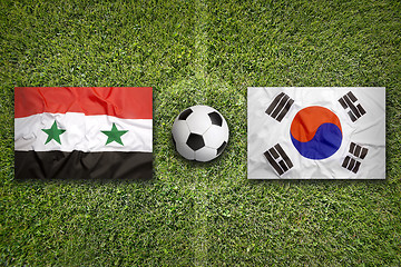 Image showing Syria vs. South Korea flags on soccer field