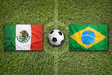 Image showing Mexico vs. Brazil flags on soccer field