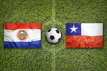 Image showing Paraguay vs. Chile flags on soccer field