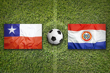Image showing Chile vs. Paraguay flags on soccer field