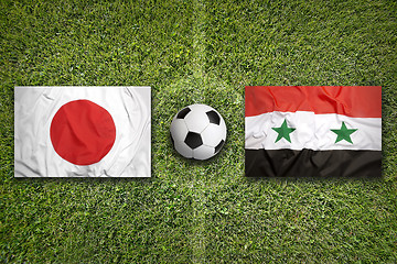 Image showing Japan vs. Iraq flags on soccer field