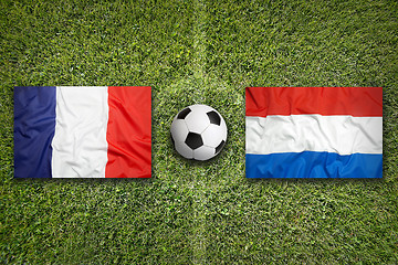 Image showing France vs. Netherlands flags on soccer field