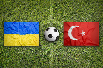 Image showing Ukraine vs. Turkey flags on soccer field