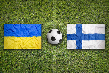 Image showing Ukraine vs. Finland flags on soccer field