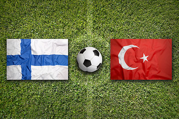 Image showing Finland vs. Turkey flags on soccer field