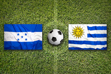 Image showing Honduras vs. Uruguay flags on soccer field