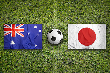 Image showing Australia vs. Japan flags on soccer field