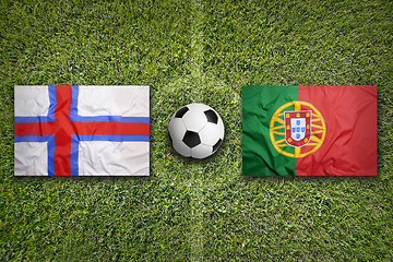 Image showing Faeroe Islands vs. Portugal flags on soccer field