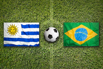 Image showing Uruguay vs. Brazil flags on soccer field