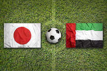 Image showing Japan vs. United Arab Emirates flags on soccer field