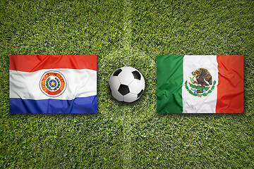 Image showing Paraguay vs. Mexico flags on soccer field