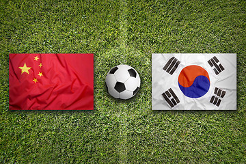 Image showing China vs. South Korea flags on soccer field