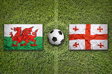 Image showing Wales vs. Georgia flags on soccer field