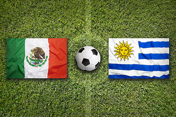 Image showing Mexico vs. Uruguay flags on soccer field