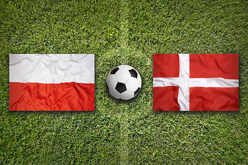Image showing Poland vs. Denmark flags on soccer field
