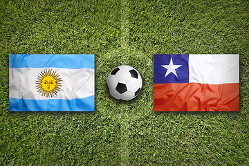 Image showing Brazil vs. Chile flags on soccer field