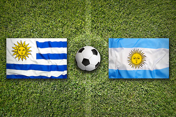 Image showing Uruguay vs. Mexico flags on soccer field