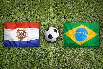 Image showing Paraguay vs. Brazil flags on soccer field