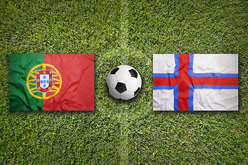 Image showing Portugal vs. Faeroe Islands flags on soccer field