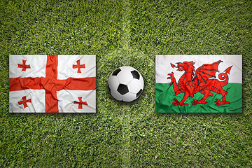 Image showing Georgia vs. Wales flags on soccer field