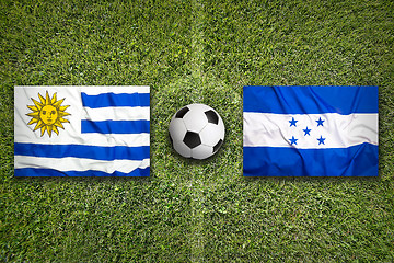 Image showing Uruguay vs. Honduras flags on soccer field
