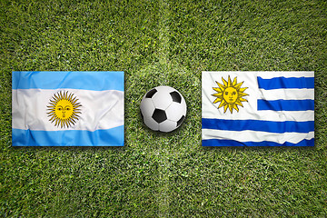 Image showing Brazil vs. Uruguay flags on soccer field