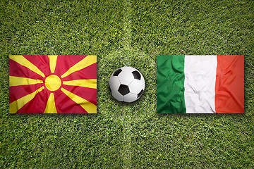 Image showing Macedonia vs. Italy flags on soccer field