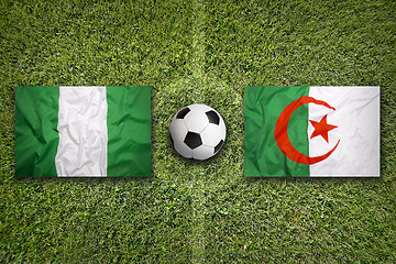 Image showing Nigeria vs. Algeria flags on soccer field