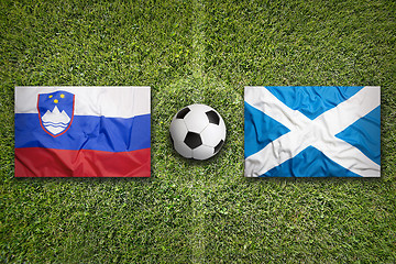 Image showing Slovenia vs. Scotland flags on soccer field