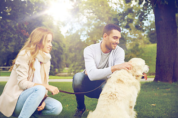 Image showing happy couple with labrador dog walking in city