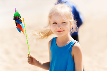 Image showing happy little girl with colorful pinwheel at summer