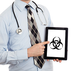 Image showing Doctor holding tablet - Warning! Biohazard!