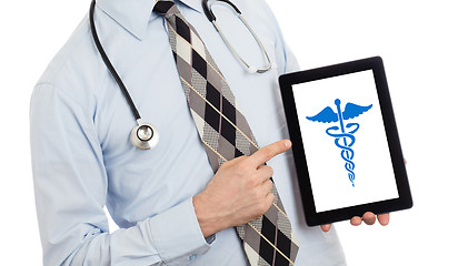 Image showing Doctor holding tablet - Caduceus symbol