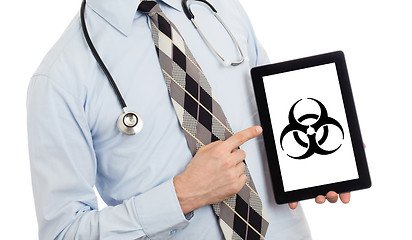 Image showing Doctor holding tablet - Warning! Biohazard!