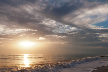 Image showing Sunset over sea and cloudy sky