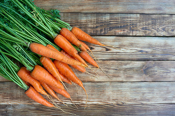 Image showing Fresh carrots bunch on rustic wooden background