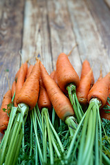 Image showing Fresh carrots bunch on rustic wooden background