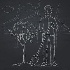 Image showing Man plants tree.