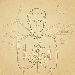 Image showing Man holding plant.