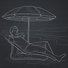 Image showing Man sitting in chaise longue.