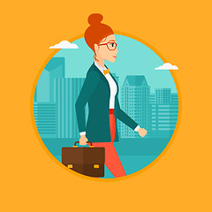 Image showing Successful business woman walking with briefcase.