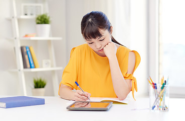 Image showing bored asian woman student with tablet pc at home