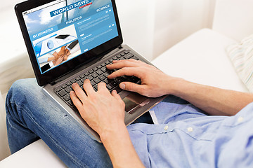 Image showing close up of man typing on laptop computer at home