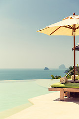 Image showing view from infinity edge pool with parasol to sea