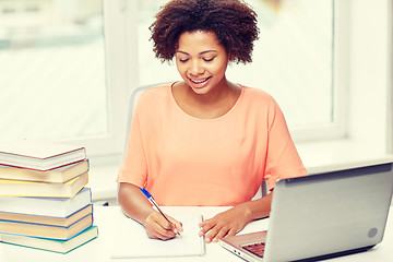 Image showing happy african american woman with laptop at home